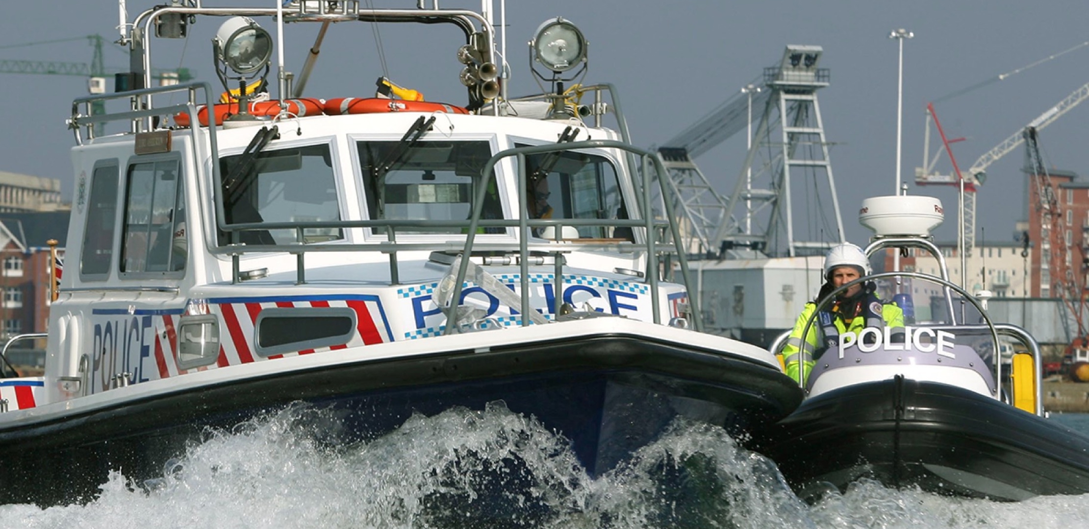 Solent Rib Charter supporting police marine operations with high-performance patrol boats operating at speed in a busy port environment.