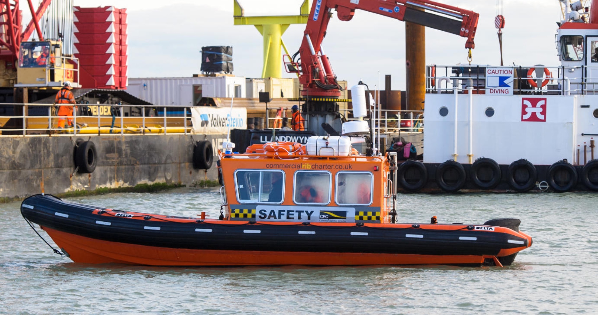 Commercial Rib Charter safety boat supporting marine construction works, providing safety cover near barges, cranes and dive operations.