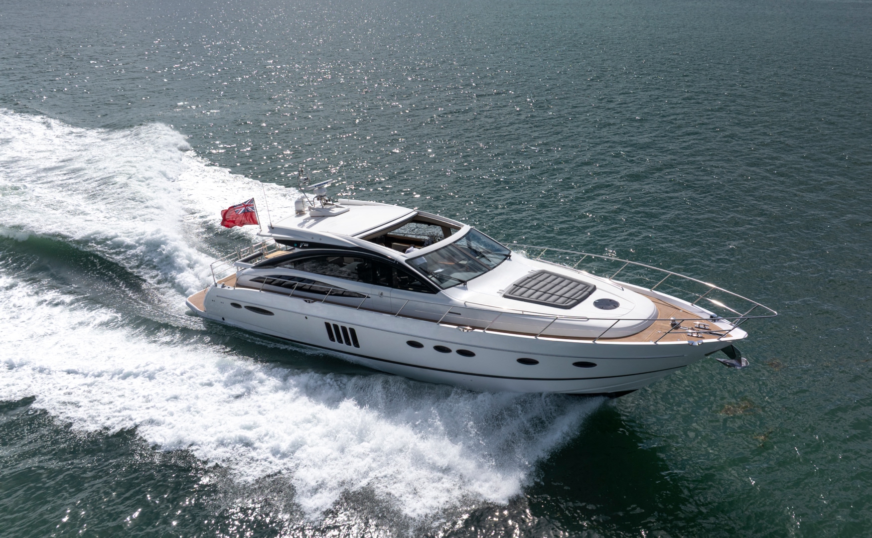 Aerial view of a luxury motor yacht cruising at speed on the Solent during a private charter with Solent Rib Charter