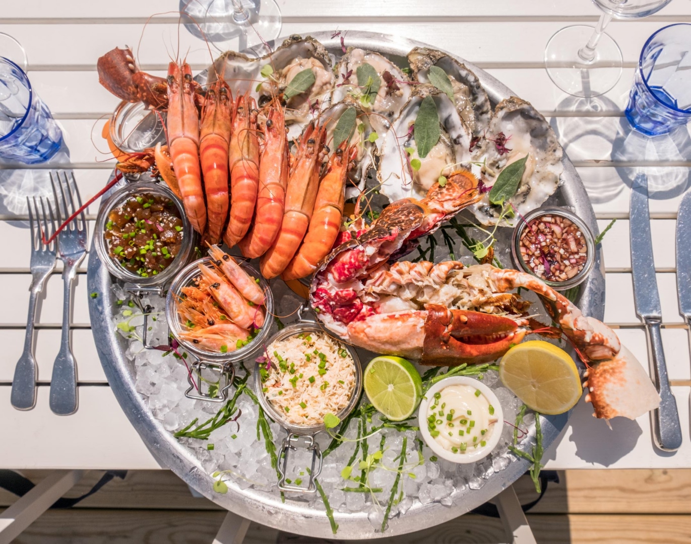 Fresh seafood platter with lobster, prawns, oysters and sauces served on ice, perfect for Solent Rib Charter waterfront dining experiences
