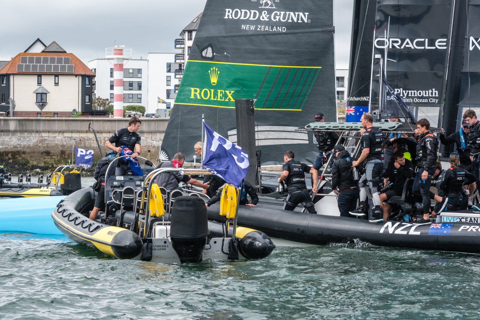 Professional RIB providing on-water support alongside an elite racing yacht during a major sailing event on the Solent