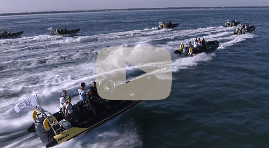 Multiple Solent Rib Charter boats racing across open water with corporate groups on board, creating an exciting large-fleet adventure on the Solent.