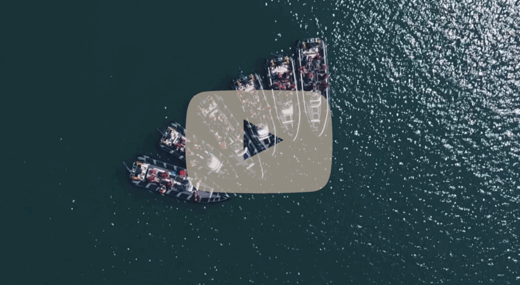 Drone shot of multiple Solent Rib Charter boats grouped together on calm open water, showcasing fleet capability and large-group corporate event capacity.