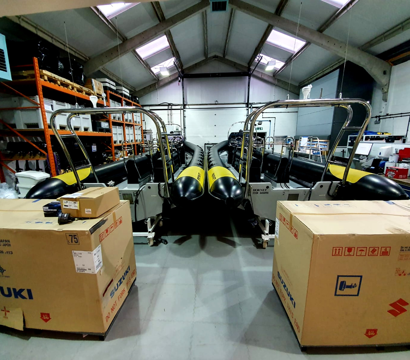 Solent Rib Charter fleet of high-performance RIB boats inside marine workshop with Suzuki outboard engines prepared for South Coast charters