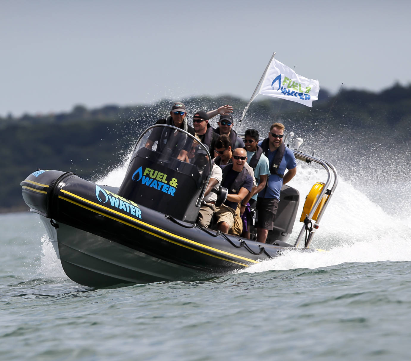 Group of people riding a high-speed RIB boat on open water