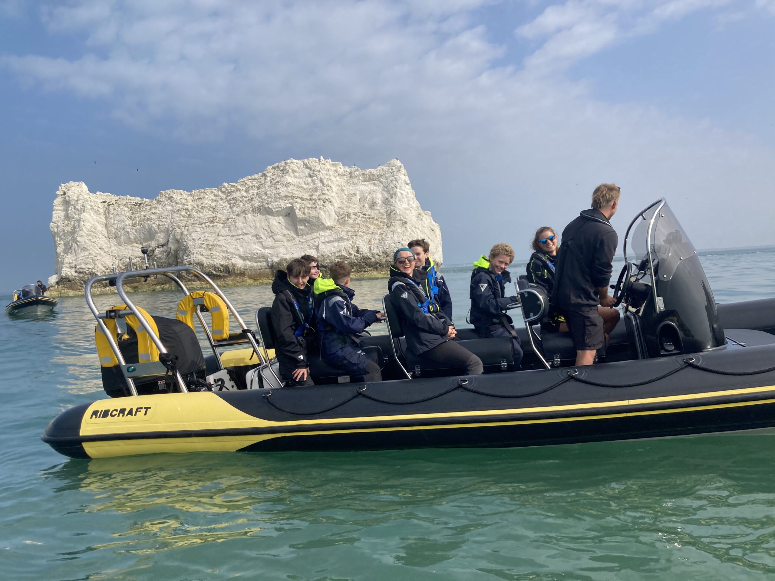 Group enjoying a high-speed RIB boat charter with Solent Rib Charter near the Isle of Wight chalk cliffs on the Solent