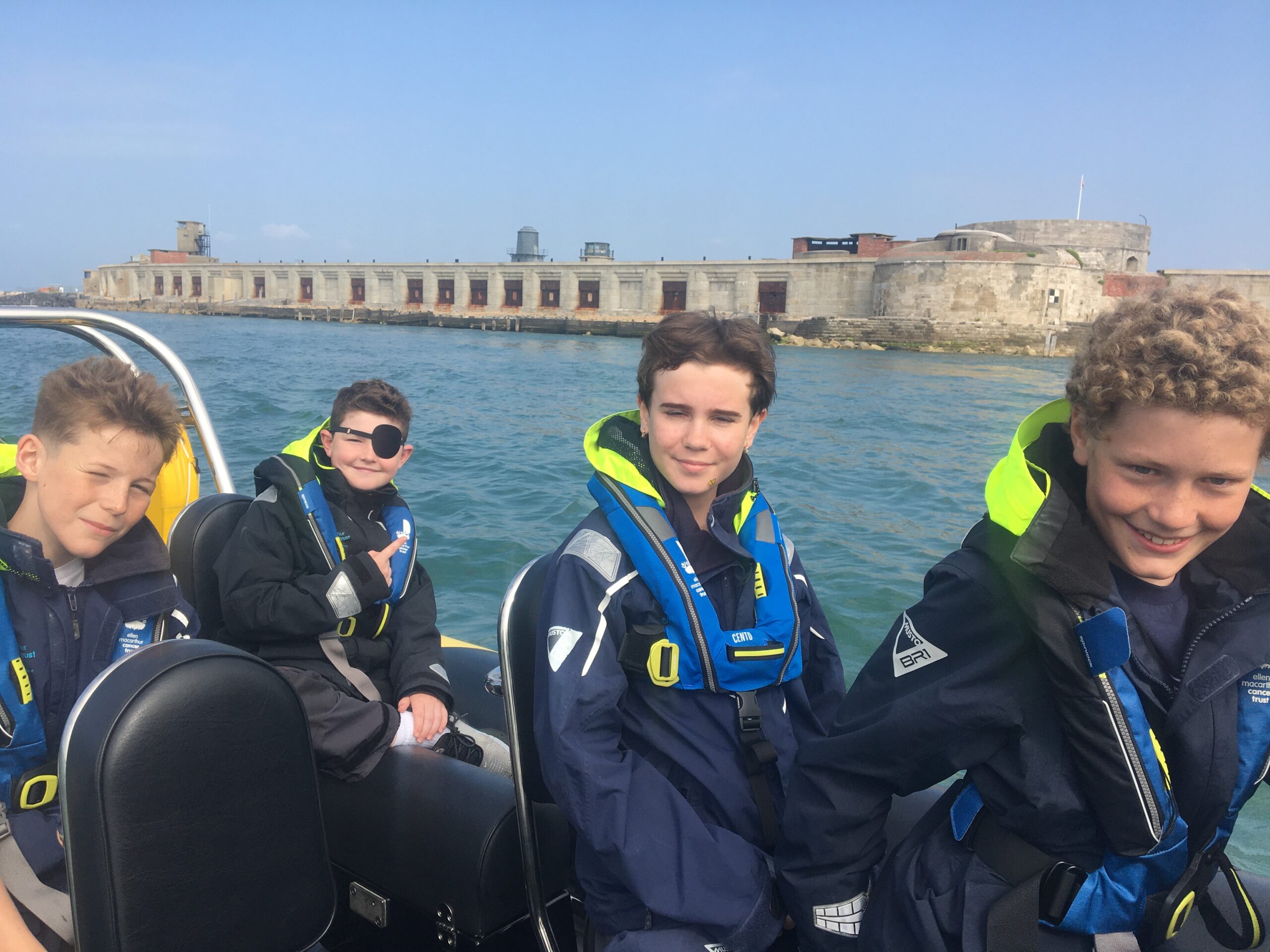 Young passengers wearing lifejackets enjoying a Solent RIB boat trip with Solent Rib Charter near Hurst Castle
